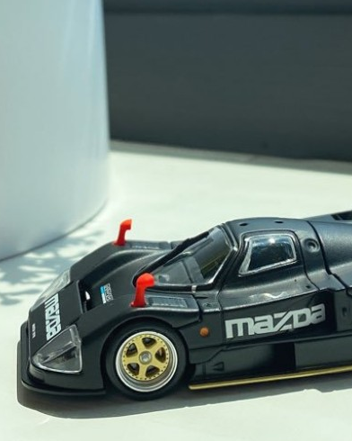 Blue rally-style diecast car on a display turntable